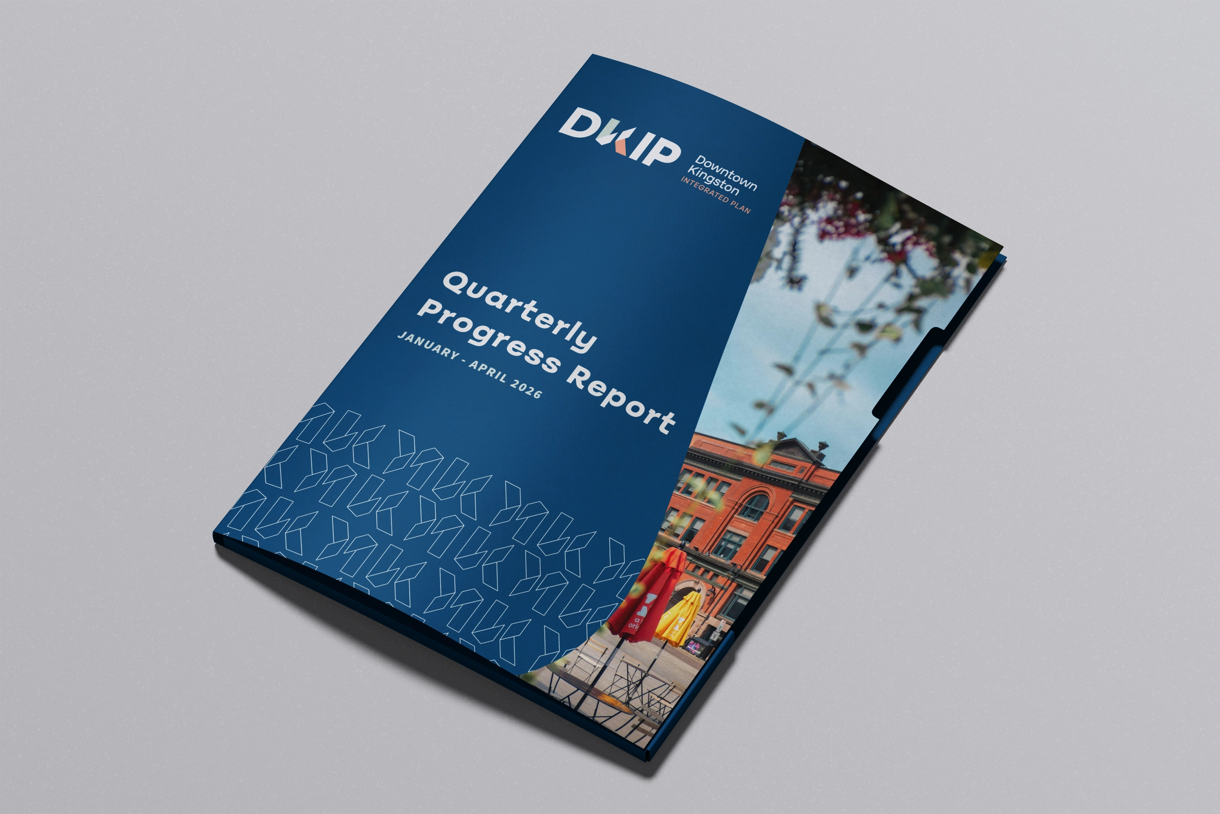 Downtown Kingston Integrated Plan binder design. Cover includes a rich dark blue with a image of a downtown kingston business peeking out the right side. Designed by Owen Denesuik.